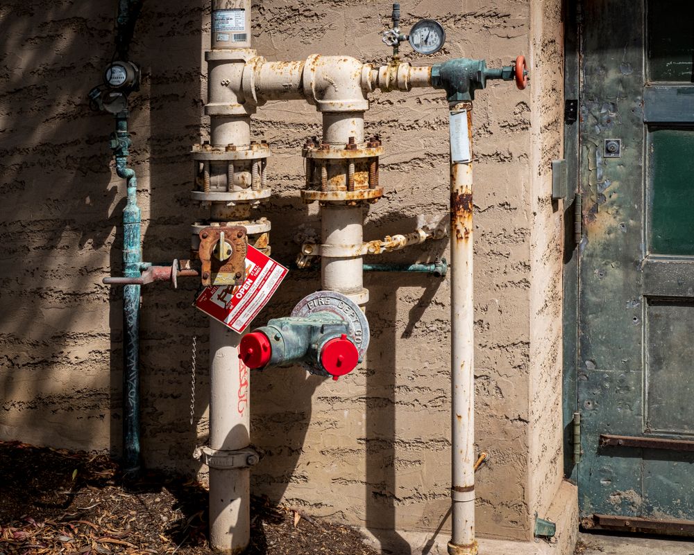Industrial pipes with control valves in a plant room