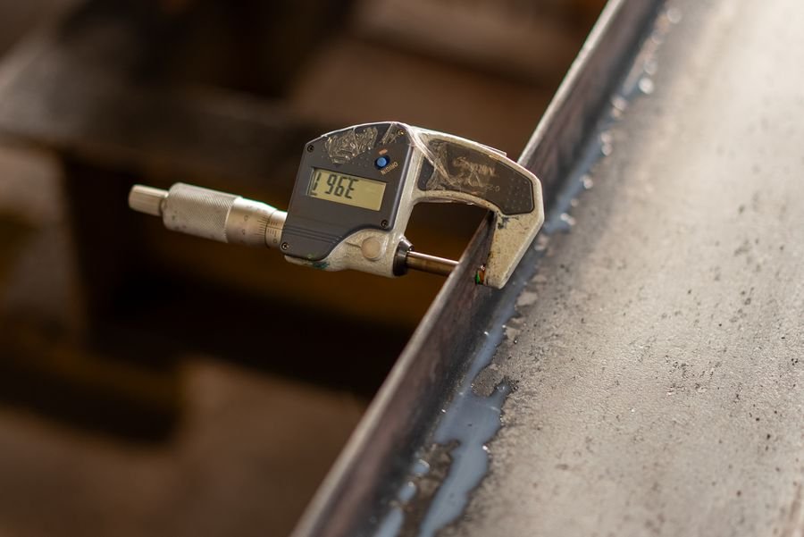 Precision digital caliper measuring metal component