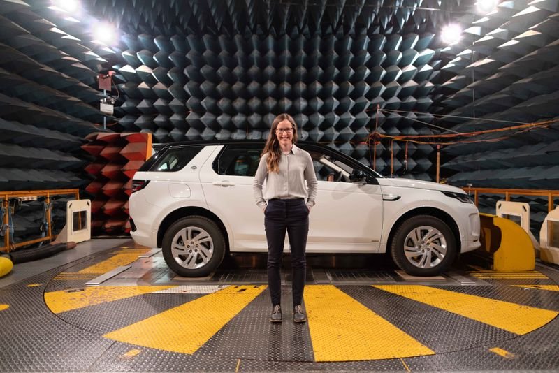 Engineer performing acoustic test in anechoic chamber
