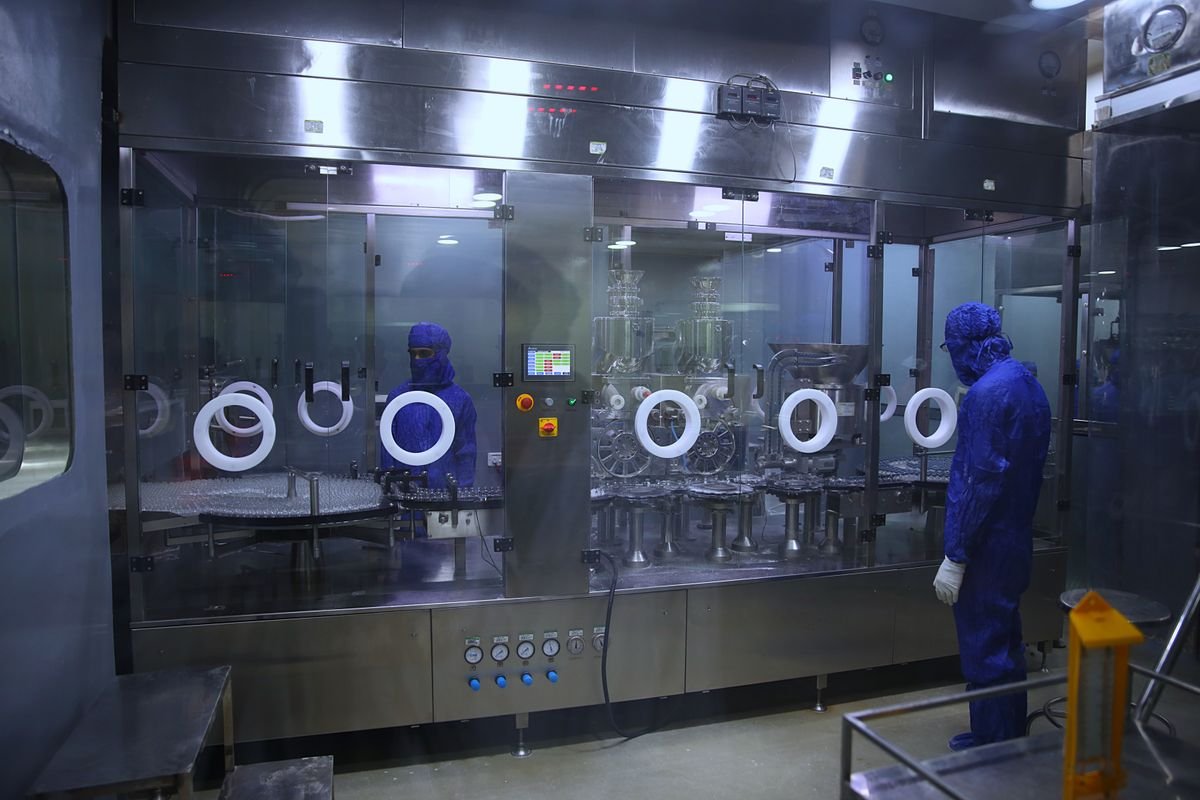 Pharmaceutical cleanroom workers in sterile manufacturing facility