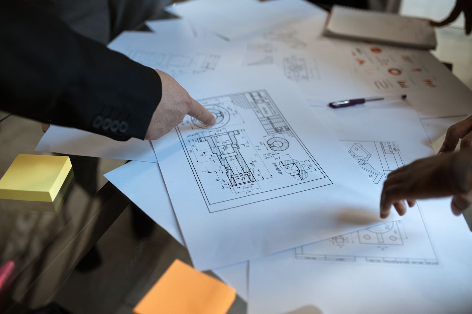 Engineers reviewing project drawings for HVAC product configuration