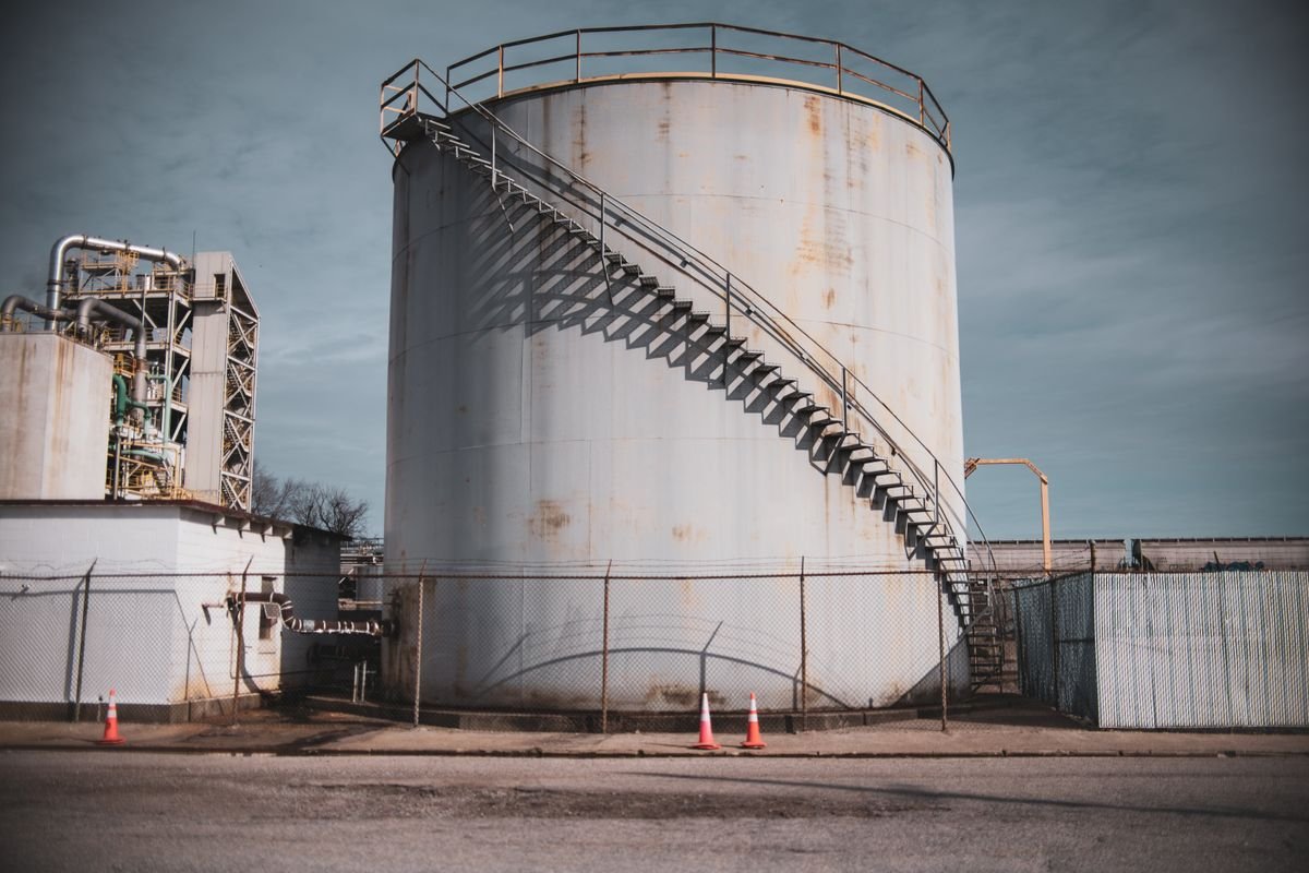 Industrial storage tank and steel structures under a clear sky