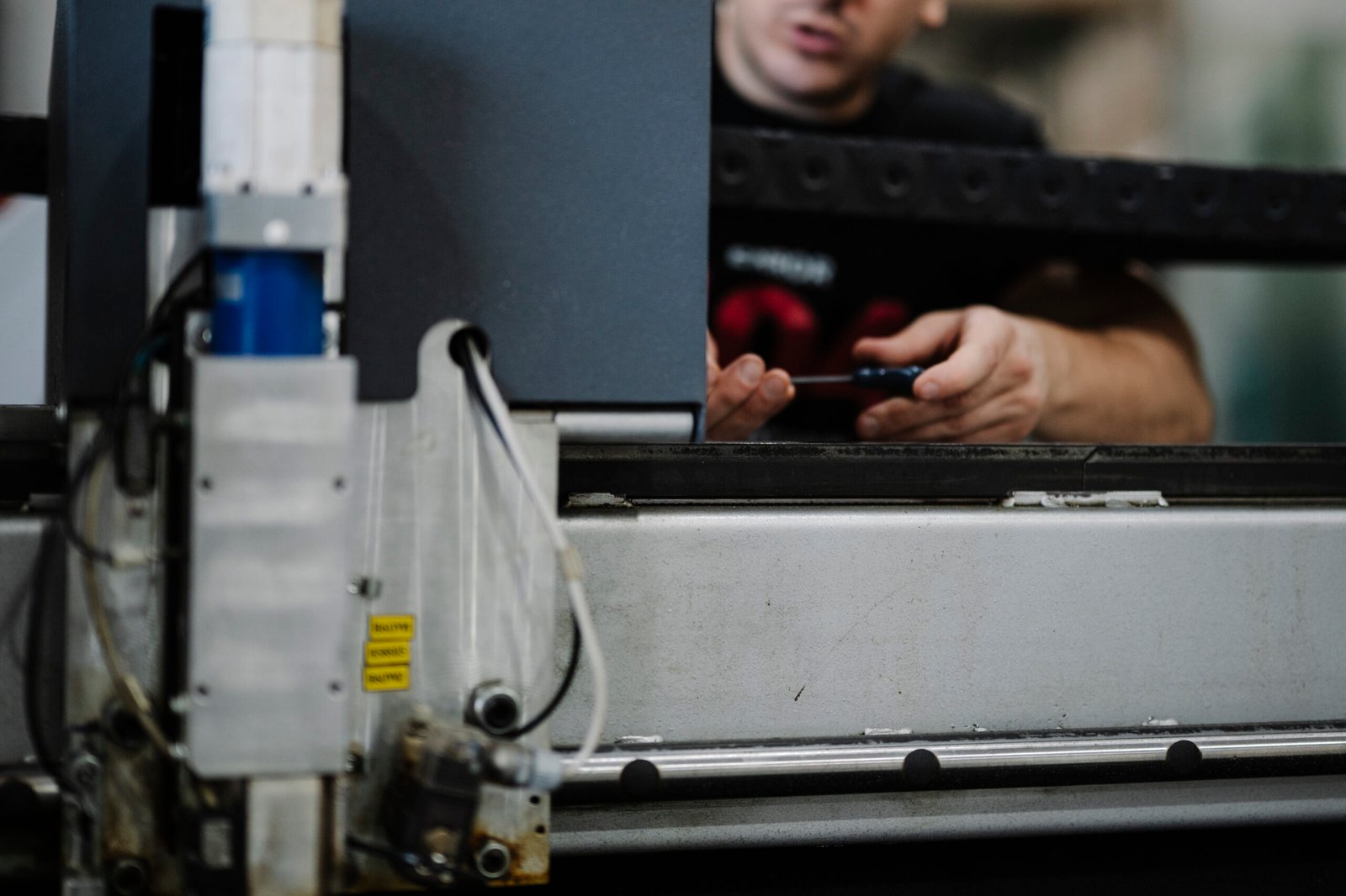 Worker configuring production equipment in a workshop
